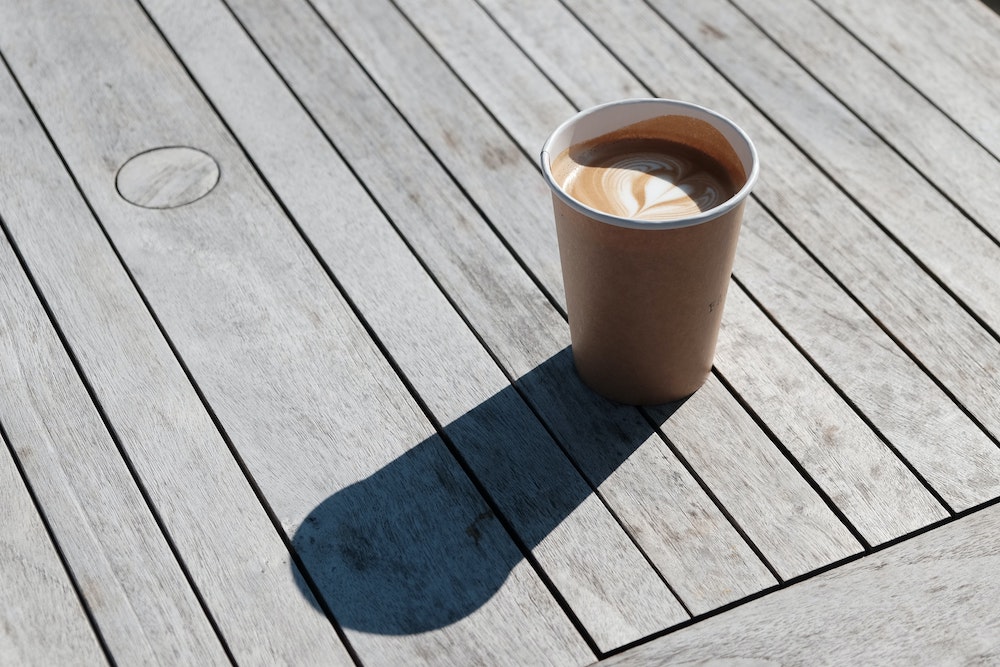 a cup of coffee sitting on an outdoor table