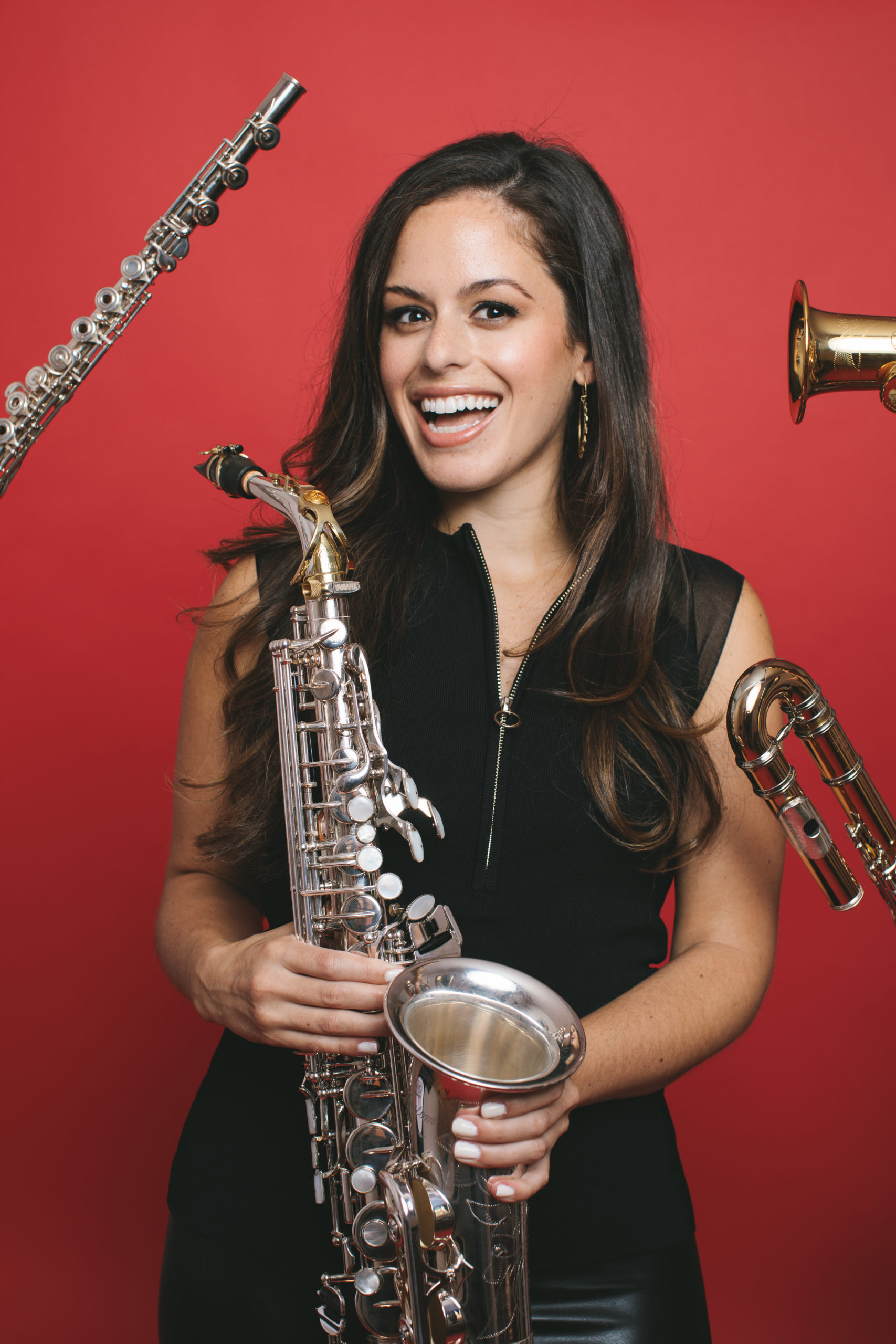 Alexa Tarantino smiling with instruments pointing every which way