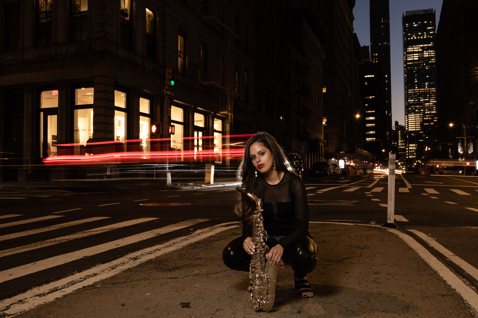 NYC street at night Alexa Tarantino with saxophone